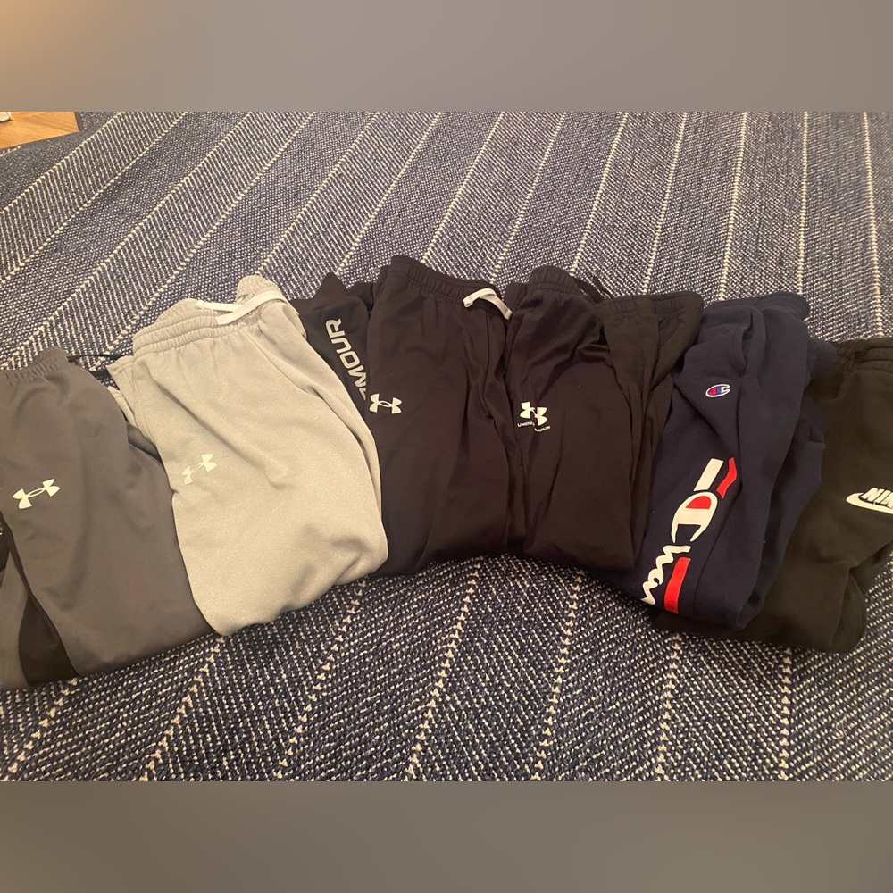 Bundle of six pairs of boys pants, (4) under Armour, (1) champion, & (1) Nike